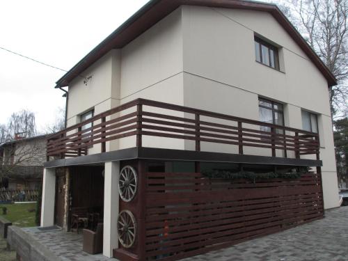 a house with a wooden fence in front of it at Tanuma Apartment in Tallinn