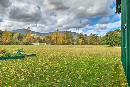 a large field with trees and mountains in the background at Luxe Green Barn Near Skiing with Mt Equinox Views! in Manchester Center