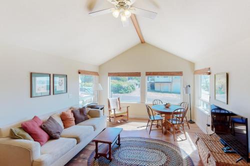 a living room with a couch and a table at Beach Cabin Getaway in Rockaway Beach