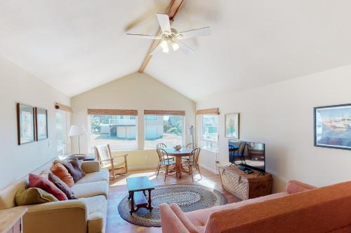 a living room with a couch and a table at Beach Cabin Getaway in Rockaway Beach