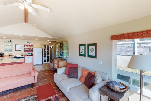 a living room with a couch and a table at Beach Cabin Getaway in Rockaway Beach