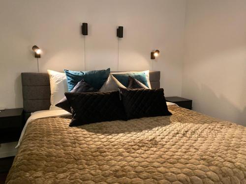 a bedroom with a large bed with pillows on it at B&B by the C in Vlissingen