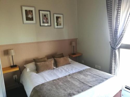 Ένα ή περισσότερα κρεβάτια σε δωμάτιο στο Logis Hotel Restaurant l'Orée Des Bois
