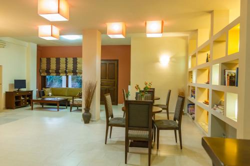 a living room with chairs and a dining room at Polichni in Leonidion