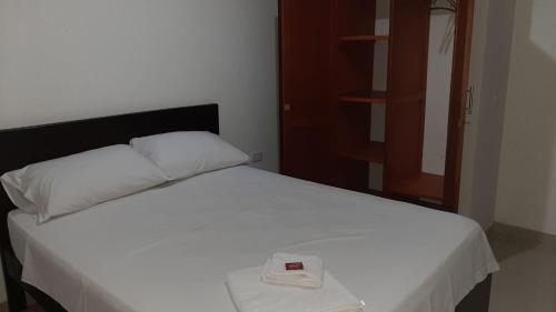 Postel nebo postele na pokoji v ubytování Hospedaje Tuuma