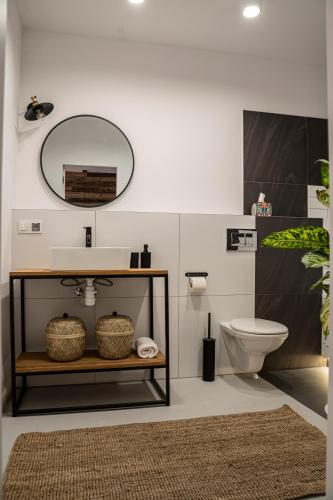 a bathroom with a sink and a toilet at Folk by Anne Apartments & Rooms in Warsaw