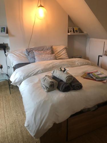 a bedroom with two beds with towels on it at The Cottage, Ashfield Place in Bristol