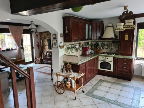 a kitchen with wooden cabinets and a table at La Bunica in Cisnadioara