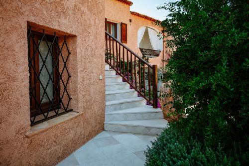 a staircase leading up to a building with a window at Relais Villa Carola in Porto Cervo