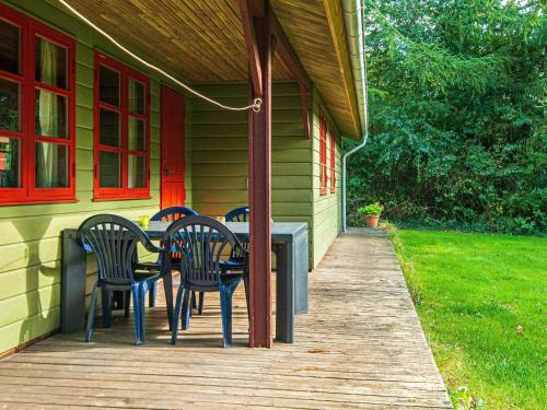 a porch with chairs and a table on a house at 6 person holiday home in Toftlund-By Traum in Arrild