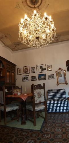 a dining room with a chandelier and a table and chairs at Vasari Home in Arezzo