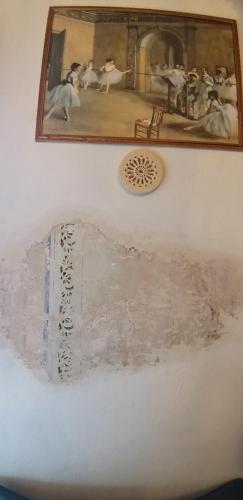a painting on a wall with a picture on it at Vasari Home in Arezzo