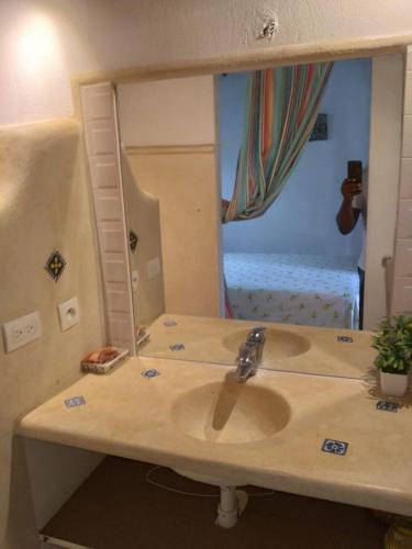 a bathroom with a sink and a large mirror at Casa Flamingo in Las Terrenas