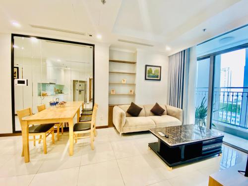 a living room with a table and a couch at Landmark - Homes by Christine in Ho Chi Minh City