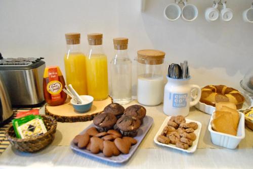 a table topped with plates of donuts and bottles of milk at B&B Casa TORET in Turin