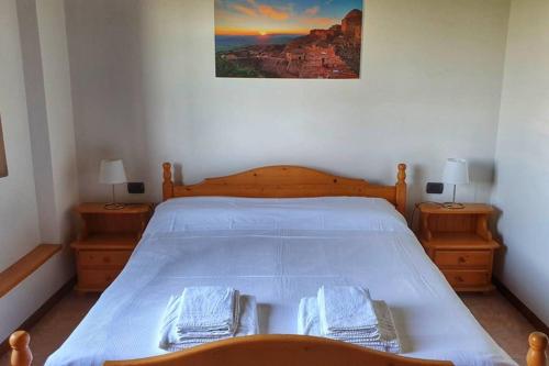 a bedroom with a large bed with two night stands at Appartamento Il Nido in Volterra