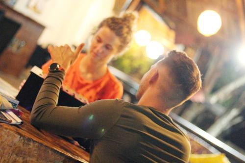 a man and a woman sitting at a barber shop at Hostal Villa Cata in El Zaino