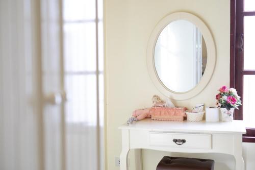 a white dressing table with a mirror on it at Sakarin Valley Resort in Kanchanaburi