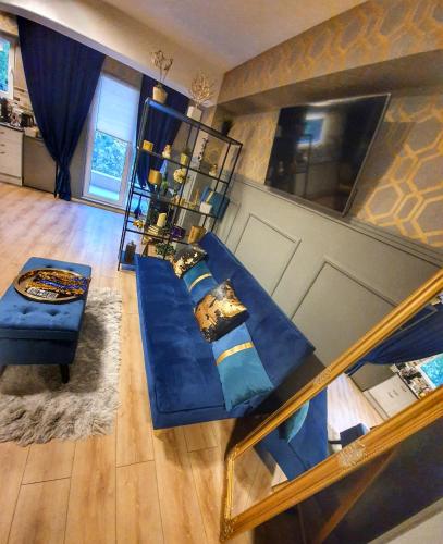 an overhead view of a living room with a blue couch at Portobella Airport Aparthotel - Self Check in in Otopeni