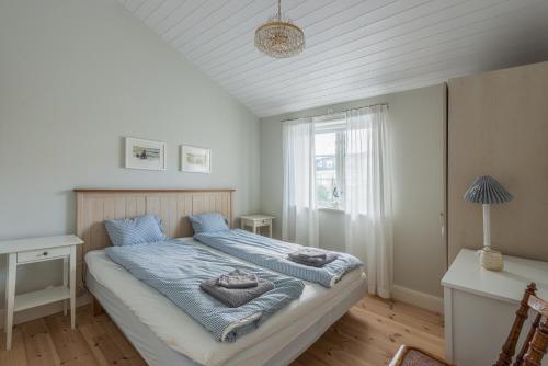 a bedroom with a bed with towels on it at Small Red House In Central Vaxholm in Vaxholm