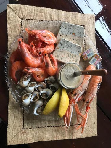 a plate of shrimp and other foods on a table at La VILLA en BAIE in Le Crotoy