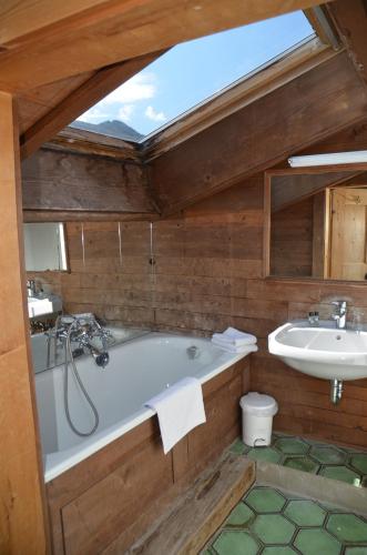 a bathroom with a bath tub and a sink at Schloss Münichau in Reith bei Kitzbühel