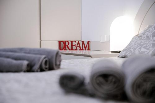 a bedroom with a bed with a dream sign on the floor at Downtown Como-Porta Torre Flat in Como