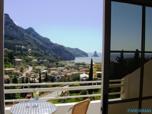 a view from a balcony with a table and chairs at Panorama apartments in Agios Gordios