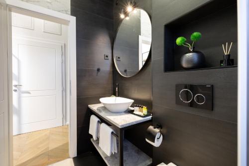 a bathroom with a sink and a mirror at DeZign Superior Apartments & Rooms in Zadar