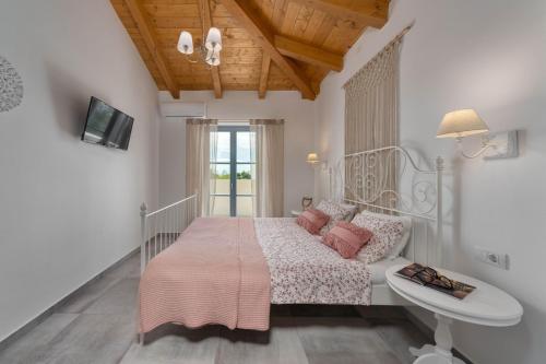 a white bedroom with a bed and a sink at Villa Aria Istria in Rovinj