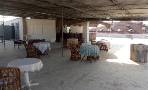 a dining room with tables and chairs and ailion at Odessa Otel Avsallar in Avsallar