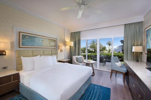 a bedroom with a large bed and a large window at Sharm Dreams Vacation Club - Aqua Park in Sharm El Sheikh