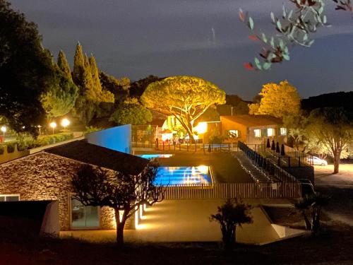 a house with a swimming pool at night at Domaine de Miremer in La Garde-Freinet