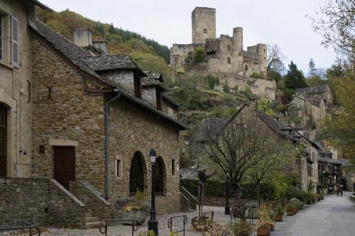an old town with a castle on a hill at Campanile Millau in Millau