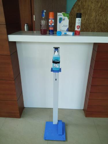 a white counter with a phone on a blue stand at Jays Inn in Munnar