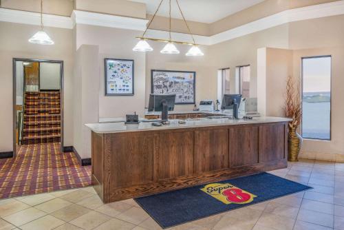 a large lobby with a large wooden reception desk at Super 8 by Wyndham Casper West by the River in Casper