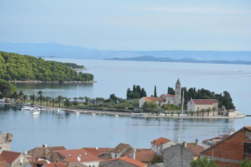 a view of a town with boats in the water at Apartment Diva in Vis