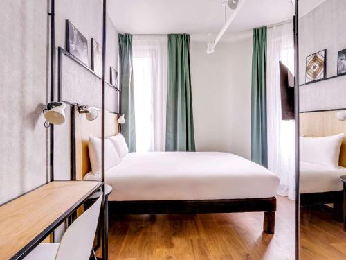 Ein Bett oder Betten in einem Zimmer der Unterkunft ibis Daumesnil Porte Doree