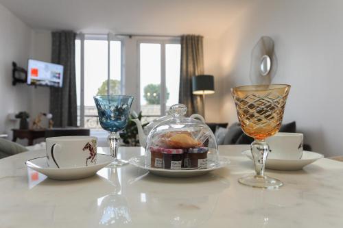a table with glasses and a plate of food on it at Cocoon Retreat in Chantilly