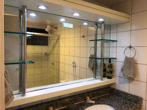 a bathroom with a sink and a mirror at Aquaville Condomínio in Aquiraz