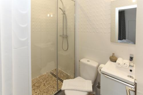 a bathroom with a shower and a toilet and a sink at Cocoon Retreat in Chantilly