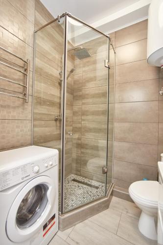 a washing machine in a bathroom with a shower at Панорамный вид на море 44 Жемчужина Аркадия in Odesa