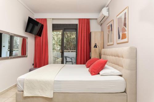 a bedroom with a large bed with red curtains at Manina SeaSide Apartment in Thessaloniki