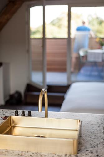 a sink in a kitchen with a counter top at B'Guest Sleep & Retreat in Bruges
