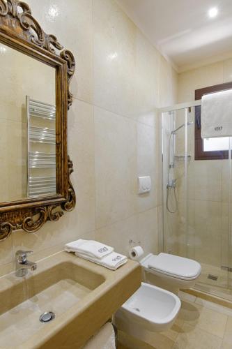 a bathroom with a sink and a toilet and a shower at Egò Salento in Galatina