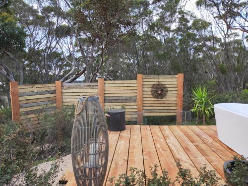 a wooden deck in front of a wooden fence at Strandmarken in Island Beach