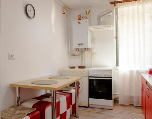 a small kitchen with a table and a stove at Casa Astilean in Lupeni