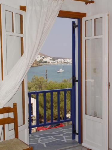 a door to a balcony with a view of the water at Ragoussis House in Logaras