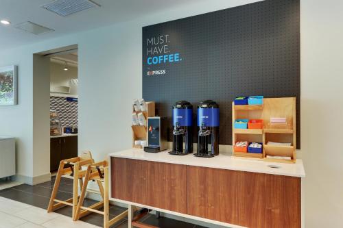 a coffee shop with a counter and chairs at Holiday Inn Express & Suites - Roanoke – Civic Center in Roanoke