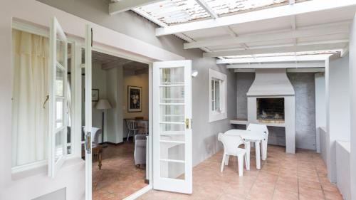 a living room with a table and chairs and a skylight at Blue Bay Lodge in Saldanha